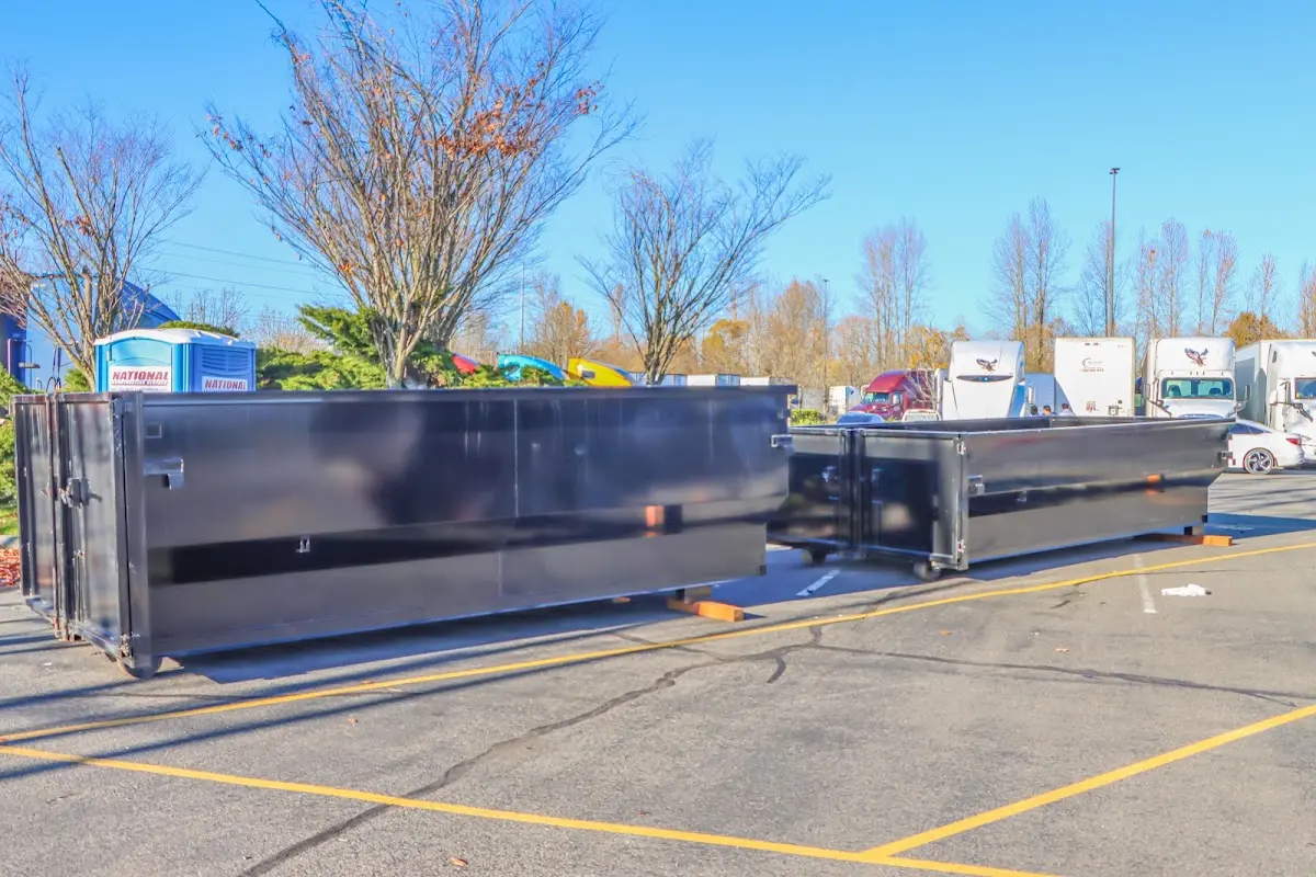 Professional dumpster rental service with roll-off container on residential driveway in Keyes